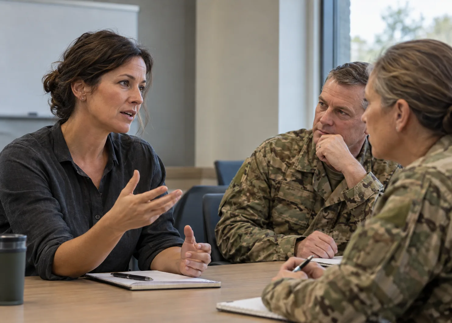 Chimney Trail expert leading a discussion with two service members at a conference table